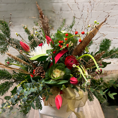 Festive Fens Basket - Festive flowers with lush and scented evergreens, Eucalyptus, pines, cones and berries. Arranged in a luxury basket adorned with fabric ribbon.