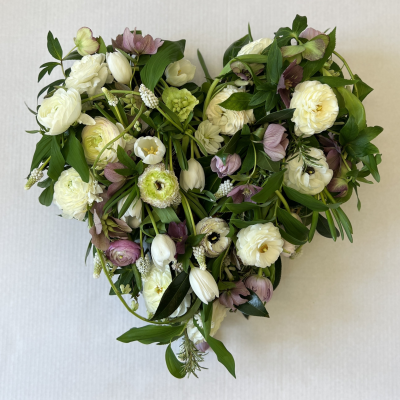 Natural heart funeral tribute. - At Evolve Flowers, we create heartfelt, bespoke funeral tributes that honour your loved one with natural beauty and care. Using sustainably sourced blooms and eco-friendly methods, each arrangement is thoughtfully designed to reflect personal memories and seasonal charm. Let us help you say goodbye with grace and meaning.
This design is a loose heart, using seasonal flowers, of which of course, you may choose colours and any varieties or leave it to us to choose. As they are seasonal, they will all look different because they use different flowers but the general style will be the same
